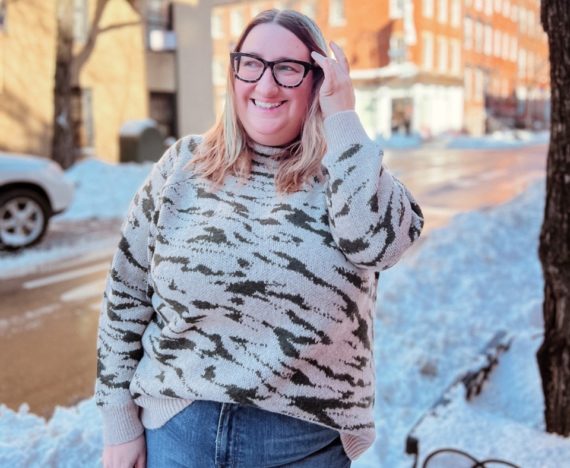 Sarah wears a plus size Madewell abstract zebra knit sweater on a snowy West Village street