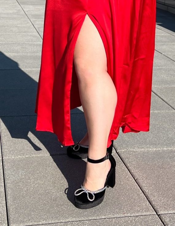 Image of Sarah's leg in a red dress with high velvet wide fit platform heels with a crystal embellishment