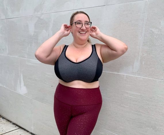 Sarah smiling in a plus size sports bra
